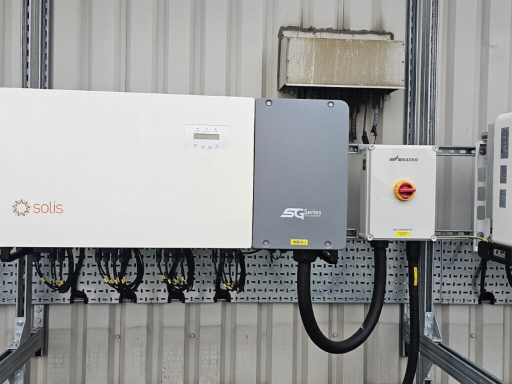 Professional solar inverter installation completed by Handy Electric Pro, featuring neatly mounted solar inverters and electrical equipment for a commercial solar power system